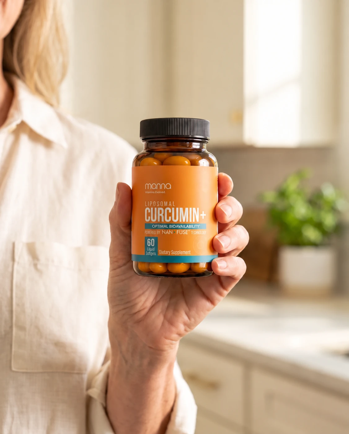Manna Curcumin+ bottle held in a hand
